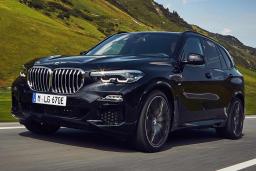 2022 BMW X5 xDrive45e in black, driving in the mountains.